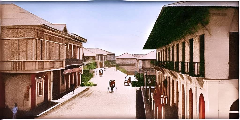 Calle Real, Iloilo, in the late 1800s: wooden houses with capiz windows along a dirt street