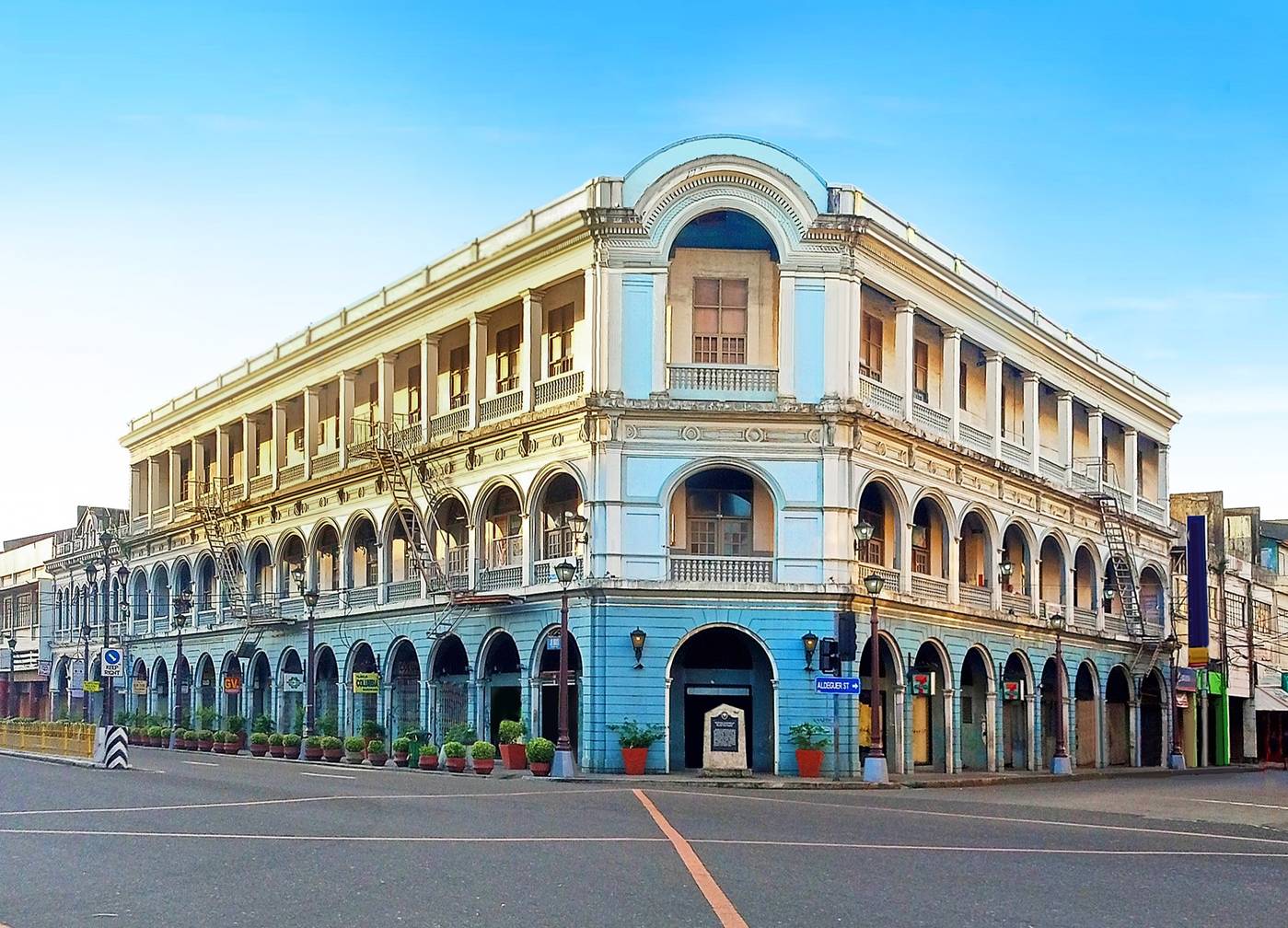 The Villanueva Building on Calle Real, Iloilo City, pale blue arcades under a clear sky